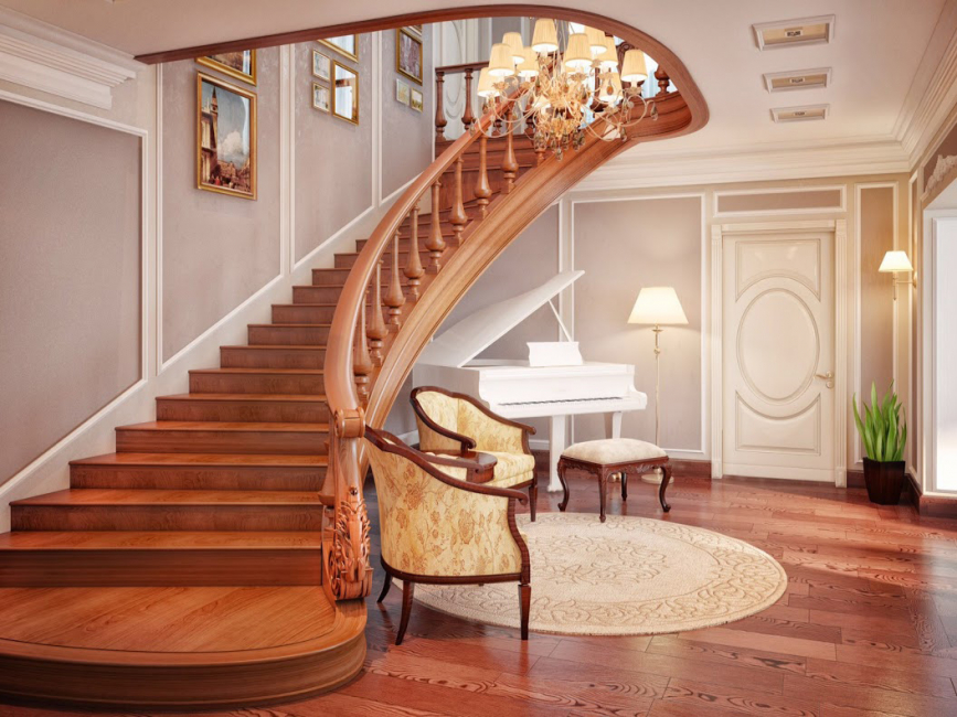 Una hermosa escalera de madera al segundo piso con un giro suave.